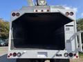 Rear view of a 2019 Freightliner M2 106 truck with an empty cargo area and utility compartments on the right side