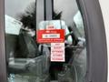 A 2005 Freightliner M2 106 truck displaying a red vehicle certification sticker with the year 2026 and months of July August September October November listed