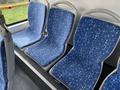 Interior of a 2016 Grande West Vicinity bus showing blue patterned seats arranged in a row without any passengers