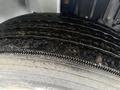 Close-up view of a worn tire from a 2020 International MV607 displaying tread wear patterns and dirt on its surface