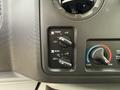 Control panel with dials for front and rear air conditioning adjustments on a vehicle