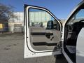 White 2020 Ford F-550 truck door open showing the interior handle and control panel on the door