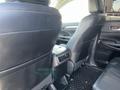 Interior of a 2018 Toyota Highlander showing black leather front seats with armrests and a console between them