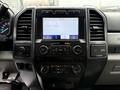 Dashboard view of a 2022 Ford F600 featuring a touchscreen display with audio and climate controls along with various buttons and knobs for vehicle settings