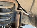 A 2016 Ford F-250 SD with visible rust and mechanical components including springs and a shock absorber