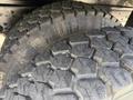 Close-up of two rugged tires featuring a deep tread pattern designed for traction on various surfaces