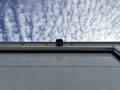 A 2018 Ford Econoline viewed from below showcasing the rear camera mounted on the top edge of the vehicle's white rear door