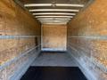 Interior of a 2012 Freightliner M2 106 truck with wooden walls and a flat floor designed for cargo transport