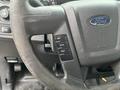 Close-up of the steering wheel of a 2013 Ford F-150 featuring buttons for info setup and reset