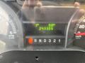 Dashboard display of a 2012 Ford E-450 Super Duty showing trip kilometers and total mileage of 243305 with gear indicator and RPM gauge