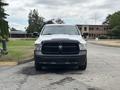 A white 2013 RAM 1500 pickup truck is seen from the front with a black grille and headlights facing directly towards the viewer