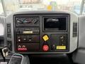 Dashboard of a 2006 International 4300 truck featuring various controls gauges and a stereo system with a storage compartment