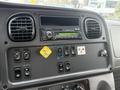 Dashboard of a 2016 Freightliner 108SD featuring a radio control panel various buttons and a parking brake indicator