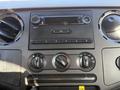 The control panel of a 2008 Ford F-550 with radio and climate control knobs