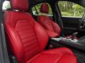 Interior of a 2023 Alfa Romeo Giulia featuring red leather front seats with distinct stitching and design details