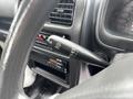 A close-up of the windshield wiper control lever inside a 2010 Suzuki Carry showing settings for mist and intermittent wipe