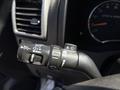 A close-up of the control stalk for headlights and windshield wipers in a 2011 Chevrolet Colorado