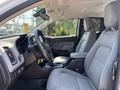 Interior of a 2017 Chevrolet Colorado featuring a steering wheel gray seats and a central console