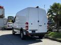 A white 2017 Mercedes-Benz Sprinter van is parked with its rear facing the viewer showcasing its sleek design and distinctive rear lights