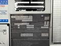 A 2021 Freightliner M2 106 truck displaying a large metal identification plate with technical specifications and operational details