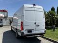 A 2019 Mercedes-Benz Sprinter van in white with a high roof and rear doors facing outward