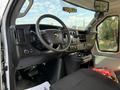 Interior view of a 2020 Chevrolet Express showing the steering wheel dashboard and controls with seating area visible