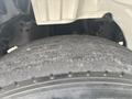 A close-up view of a worn tire on a 2006 Freightliner M2 106 showing visible tread wear and cracks on the surface