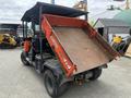 A 2011 Kubota RTV 1140 CPX with a raised dump bed showcasing its rugged design and 4x4 capabilities