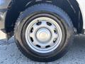 A close-up view of a silver alloy wheel and black tire from a 2019 Ford F-150