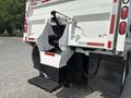 A 2013 International WorkStar garbage truck with a rear loader designed for waste collection featuring a hydraulic lift and mechanical components for dumping