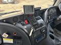Dashboard of a 2012 Autocar Xpert featuring various buttons, a display monitor, key ignition, and control panels for vehicle operation