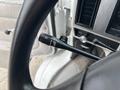 A close-up view of the turn signal and wiper control stalk in a 1994 GMC Vandura 3500 featuring a black handle with indicator symbols