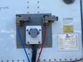 A panel mounted on a vehicle with two metal connectors one with a blue wire and the other with a red wire along with a warning label and specification details