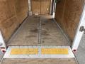 An empty 2016 Continental cargo trailer interior featuring a wooden floor with metal tie-down tracks running along the center and a metal ramp at the rear