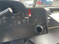 Dashboard of a 2018 Ford Econoline displaying various switches knobs and a cup holder