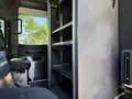 Interior view of a 2004 American LaFrance Eagle showing metal shelves and black seating in the cab area