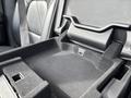 An empty storage compartment in the front console of a 2021 RAM 1500 with textured material and a USB port visible inside
