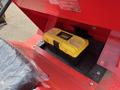 A yellow and black toolbox with a transparent lid is displayed inside the compartment of a red industrial machine