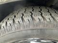 Close-up view of a black tire from a 2015 Dodge Charger showcasing the tread pattern and sidewall details