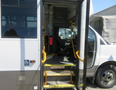 2020 Chevrolet Express with open door and steps leading into the vehicle featuring accessible handrails inside