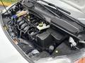 Close-up view of the engine compartment of a 2019 Ford Transit Connect showing various engine components and fluids