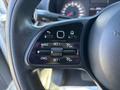 Close-up of the steering wheel controls of a 2021 Mercedes-Benz Sprinter 2500 featuring buttons for cruise control settings and adjustments