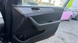 The interior door panel of a 2018 Hyundai Sonata featuring a sleek design with a handle and window controls