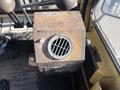 A rusty metal box with a vent grille on top located on the dashboard of a 1993 Hyster H80XL forklift