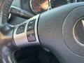 Close-up of the steering wheel of a 2006 Pontiac G6 featuring control buttons for cruise control and turn signals