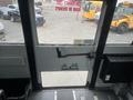 Interior view of a 2007 Freightliner B2 bus door with an emergency exit sign and a handle that indicates the door should be pulled to open