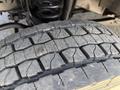 Close-up of a worn tire tread on a 2019 Ford F-550 showing visible cracks and grooves on the surface designed for traction