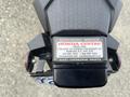 Close-up of a 2018 Honda Grom's rear view showing the tail light and license plate holder with an authorized service label attached