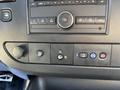 Dashboard panel of a 2019 GMC Savana featuring control buttons for audio settings and climate controls