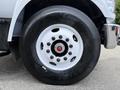 Close-up of a 2017 Ford F-750 wheel featuring a white rim and black tire showcasing the tread pattern and lug nuts